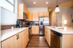 Galley style kitchen with all stainless steel appliances 